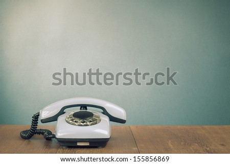 Retro telephone on table for old style background