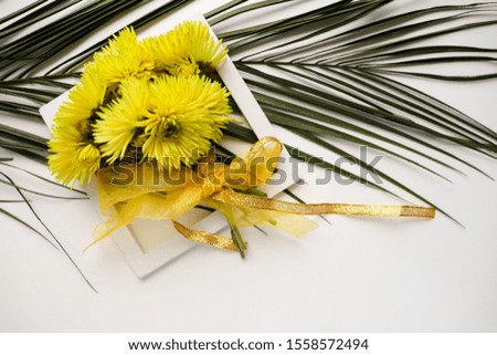 a bouquet of yellow flowers and a palm branch