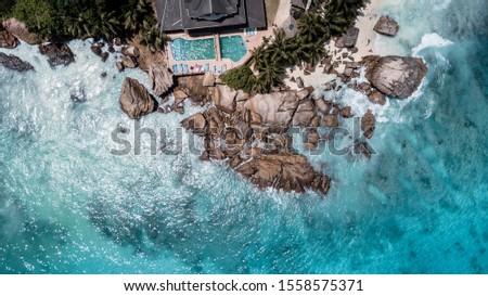 Paradise beach and hotel with beautiful deep blue water in lovely exotic Seychelles 