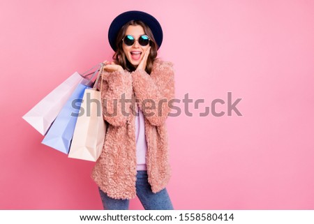 Photo of pretty lady hold carry many packs shopper tourism abroad look unbelievable sale prices hand on cheek store wear jacket sun specs hat jeans isolated pink background