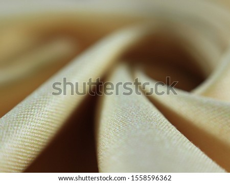 abstract background texture yellow or orange smooth cloth waves with blurred.The image clearly shows the texture.
