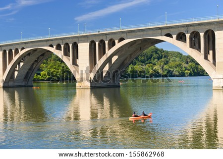 Washington DC,Key Bridge and mirror reflection over Potomac River with kayaking people  