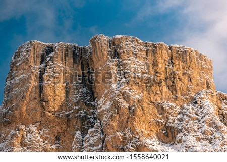 Snow covered mountain with snow in Italian Alps  during winter in sunny winter day with blue sky