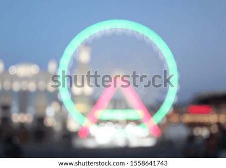 
Blurred background with ferris wheel. Holiday