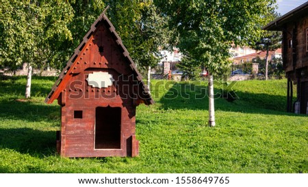 kennel in the garden with grass and trees