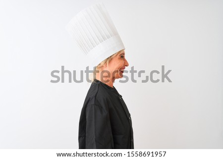 Middle age chef woman wearing uniform and hat standing over isolated white background looking to side, relax profile pose with natural face with confident smile.