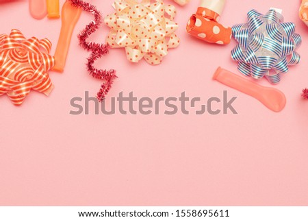 Celebration pink background with above various party bow,balloon,blowers accessories.Christmas concept,with decoration for New Year concept copy space,Top view,flat lay