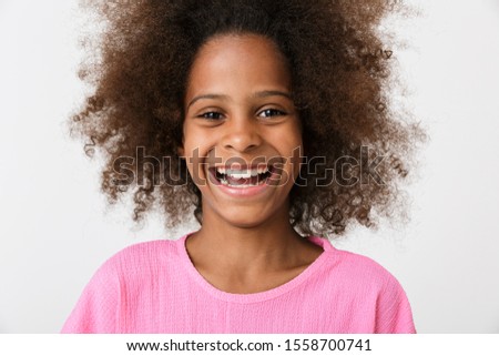 Image of a happy laughing young african girl kid posing isolated over white wall background.