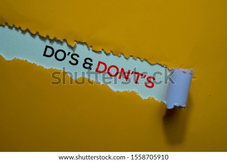 Do's & Don't's Text written in torn paper