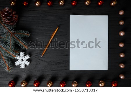 Merry Christmas and Happy Holidays greeting card, frame, banner. New Year. Noel. Silver, white and red Christmas ornaments and fir tree on black background top view. Winter holiday xmas theme. 