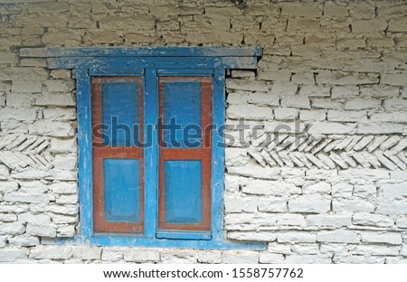 Blue pastel window on the white Stone house wall - texture background - image from nepal poonhill 