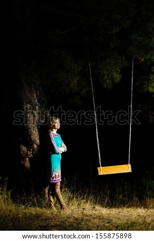 beautiful girl sitting on a swing