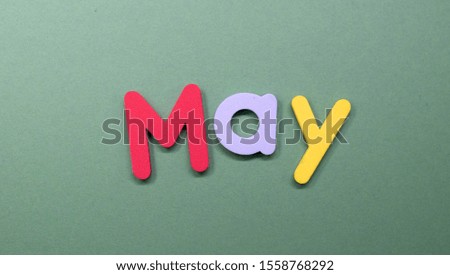 Word May written with color sponge