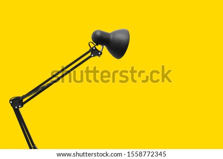 Desk lamp on yellow background. Creative concept.