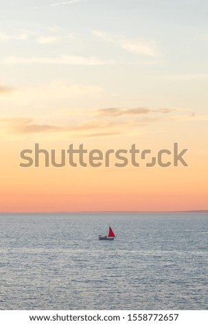 
Red sail in the Black Sea. Yacht with a red sail against the sky.