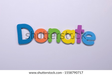Word "Donate" written with color sponge