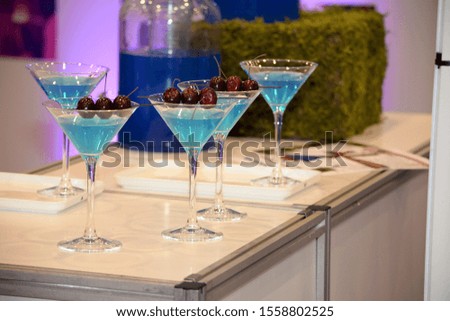 Blue coctail with cherry close up photography