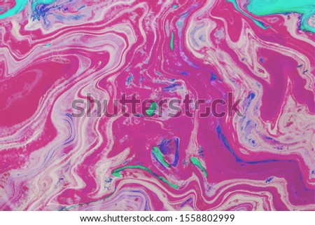 Abstract colorful liquid marble pattern texture. Fluid art. Multi color of acrylic and oil paint mixed. Pink tone background.