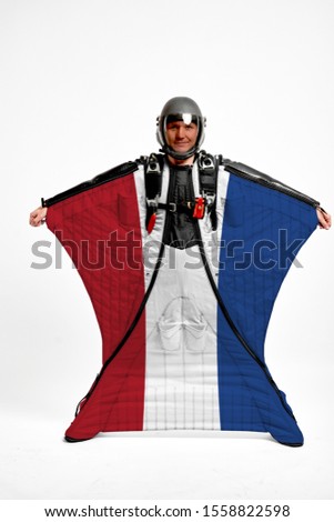 Netherlands flag travel. Bird Men in wing suit flag. Sky diving men in parashute. Patriotism, men and flag.
                               