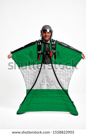 Nigeria flag travel. Bird Men in wing suit flag. Sky diving men in parashute. Patriotism, men and flag.
                               