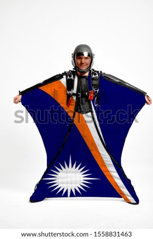 Marshall Islands flag travel. Bird Men in wing suit flag. Sky diving men in parashute. Patriotism, men and flag.
                              