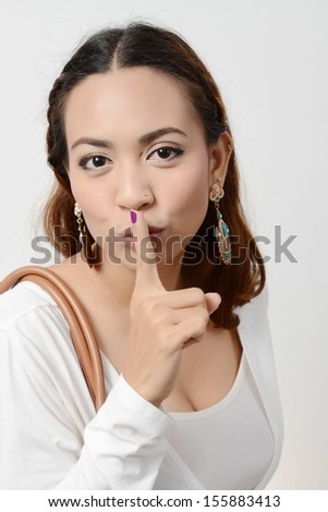 Young Asian women showing silence symbol
