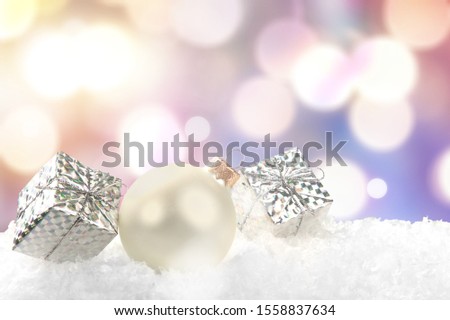 Silver shiny christmas balls in snow