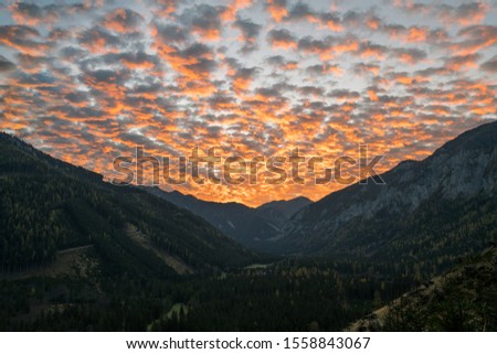 This picture was taken in Austria, portraining the breathtaking landscape and showing a valley during sunrise.