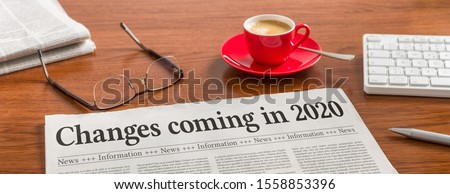 A newspaper on a wooden desk - Changes coming in 2020 Royalty-Free Stock Photo #1558853396