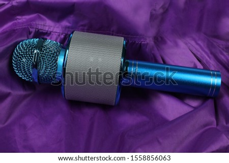blue microphone on purple background