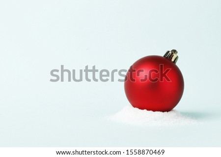 Red christmas ball on a blue background. Place for text.