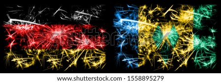 Germany, German vs Saint Vincent and the Grenadines New Year celebration travel sparkling fireworks flags concept background. Combination of two abstract states flags.
