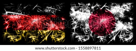 Germany, German vs Japan, Japanese New Year celebration travel sparkling fireworks flags concept background. Combination of two abstract states flags.
