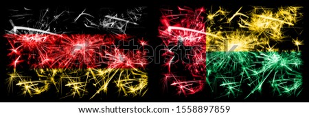 Germany, German vs Guinea Bissau New Year celebration travel sparkling fireworks flags concept background. Combination of two abstract states flags.
