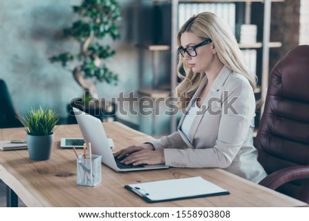 Profile photo of amazing blond business lady resourceful person looking seriously notebook texting colleagues sit boss chair formalwear blazer in modern office Royalty-Free Stock Photo #1558903808
