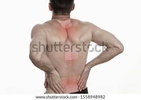 Medicated pain relief patch, plaster. man with back pain. Pain relief and health care concept isolated on white. Royalty-Free Stock Photo #1558948982