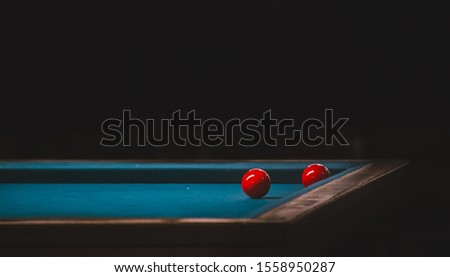 two red balls on a pool table