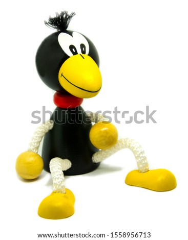 Toy, wooden crow on a white background.