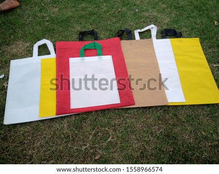 Eco Friendly Bags, Non Woven Bags, Multi Color Bags on green grass