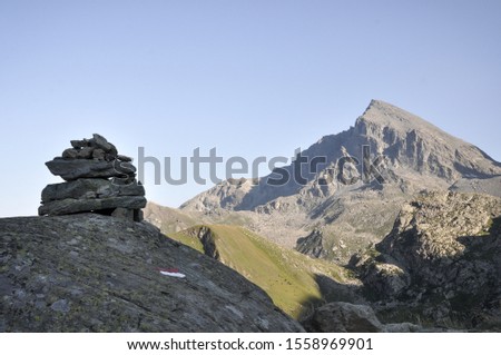 mountains of the Italian Alps with lakes and paths, blue sky
