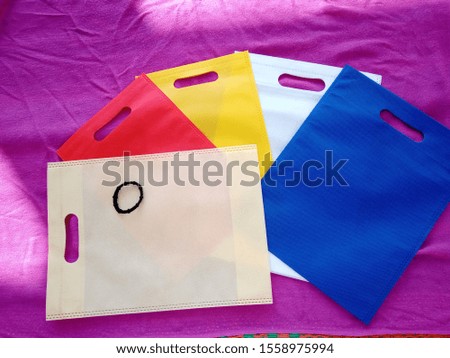d cut model Eco Friendly Bags on purple background , Non Woven Polypropylene Bag, Reusable shopping bag