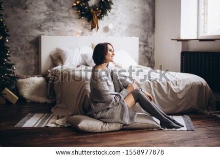 happy young woman with bed at home in bedroom