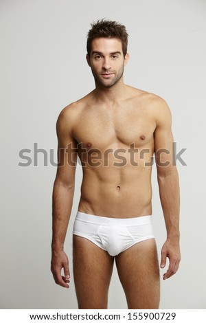 Portrait of mid adult man in briefs, studio shot Royalty-Free Stock Photo #155900729