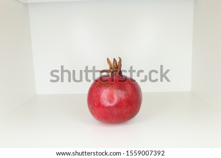 
juicy pomegranate on a white background. beautiful contrast. natural color