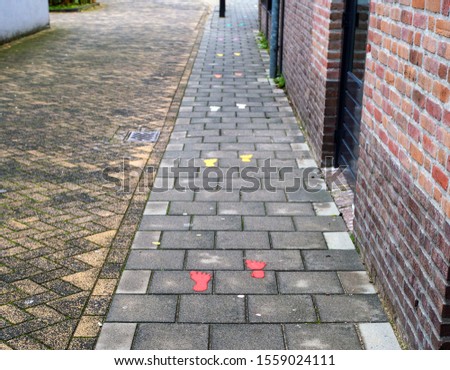 Sidewalk with painted colorful footsteps for children outside rainbow