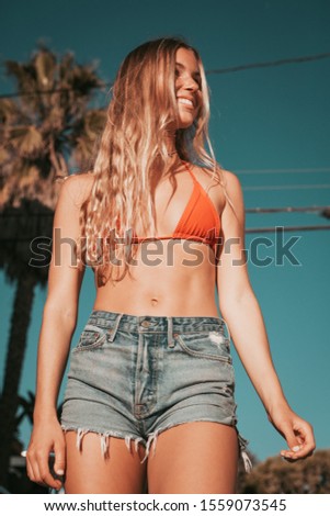 young woman with a bikini and shorts. california