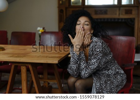Portrait of beautiful African American girl with coffee. Portrait of beautiful young black woman smiling. Happy cheerful beautiful african girl in leopard print dress enjoy sleeps Royalty-Free Stock Photo #1559078129