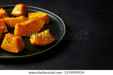 pieces of roasted pumpkin with herbs