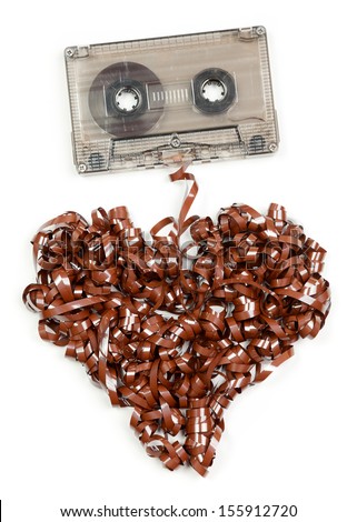 Vintage transparent Compact Cassette with pulled out tape in the shape of heart on white background