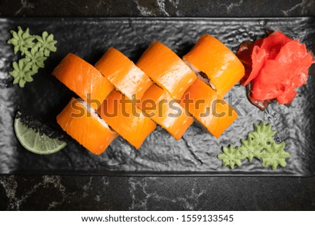 rolls on black background.rice and fish